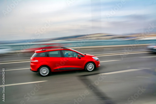 Car driving fast motion on highway side view