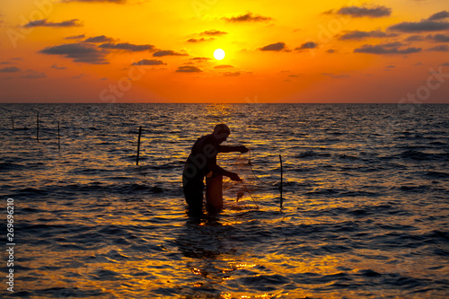 Picture of a Fisherman using net to catch fish during sunset, Poti, Georgia