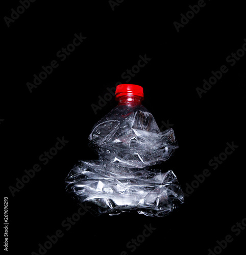 Empty plastic bottle isolated on black background. Nature protection concept.