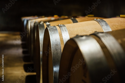 Aligned wine barrels in a cellar