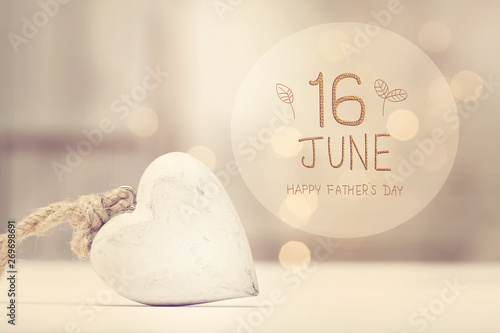 Fototapeta Naklejka Na Ścianę i Meble -  Father's Day message with a white heart  in a room