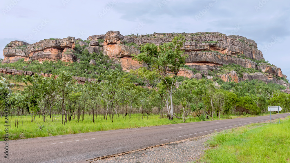 Beautiful view of Nourlangie Rock or Burrunggui in Kakadu Park on a sunny day with some clouds, Australia