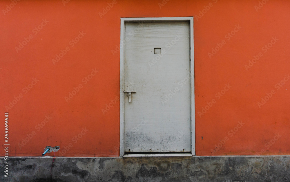 classic door with orange wall