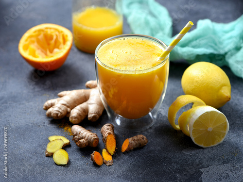 Turmeric or curcuma drink with ginger, healthy detox vitamin orange juice