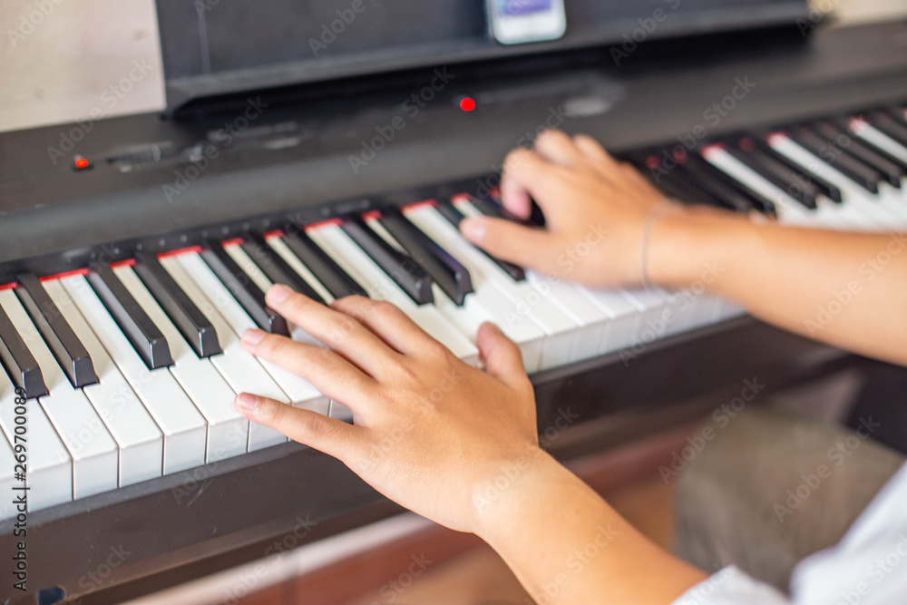 Young Asian man playing classical piano jazz music concert indoors relax time antidepressant music therapy concept Young Asian man playing classical piano jazz music concert indoors relax time antidepressant music therapy concept