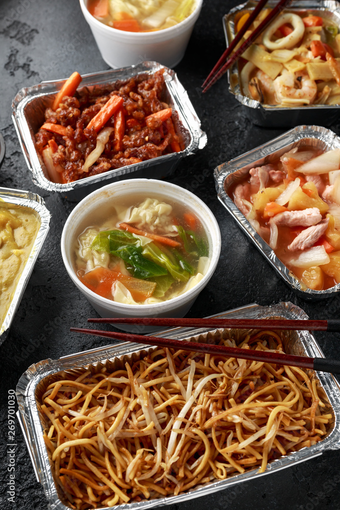 Chinese takeaway food. Pork Wonton dumpling soup, Crispy shredded beef, sweet and sour pineapple chicken, egg noodles with bean sprouts, curry. Chinese takeaway food. Pork Wonton dumpling soup, Crispy shredded beef, sweet and sour pineapple chicken, egg noodles with bean sprouts, curry.