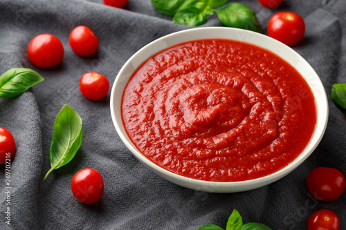 Homemade tomato Passata in white bowl with basil