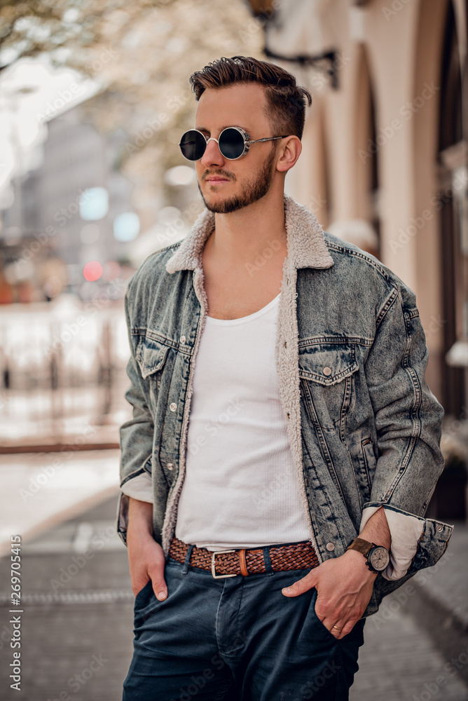 Stylish beautiful man posing on the street Stylish beautiful man posing on the street
