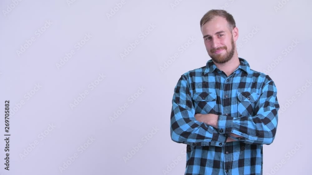 Happy bearded hipster man touching something and crossing arms Happy bearded hipster man touching something and crossing arms