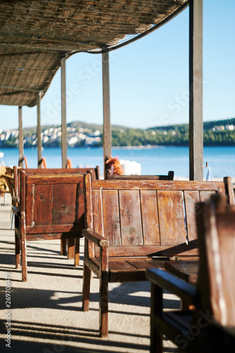 Relaxing beach bar with wooden benches in Trogir, Croatia