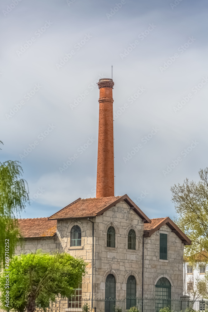 Viseu / Portugal - 04 16 2019 : View of the Museum of electricity, top building with chimney in industrial brick, in the enclosure of the market of São Mateus in Viseu