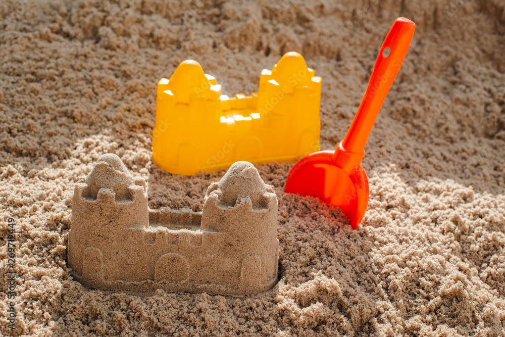 Children toys for build the sandcastle, Shovel, Molds laying on the sand at the seashore, Children toys for build the sandcastle, Shovel, Molds laying on the sand at the seashore,