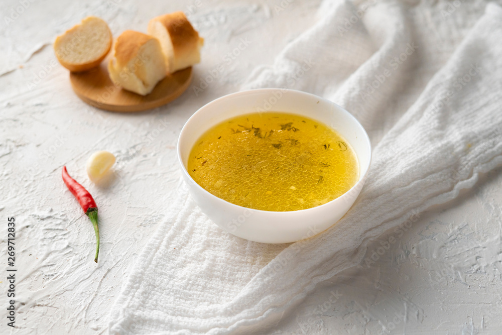 home cooked boullion or clear soup in a ceramic bowl at the kitchen, healthy food and diets home cooked boullion or clear soup in a ceramic bowl at the kitchen, healthy food and diets