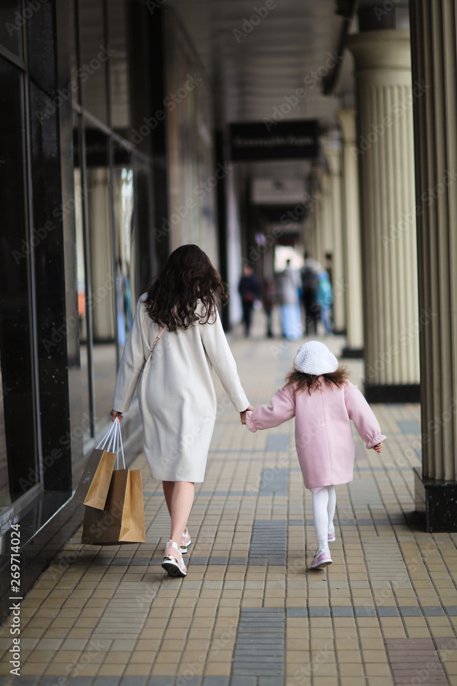 mom and daughter with long dark are walking mom and daughter with long dark are walking