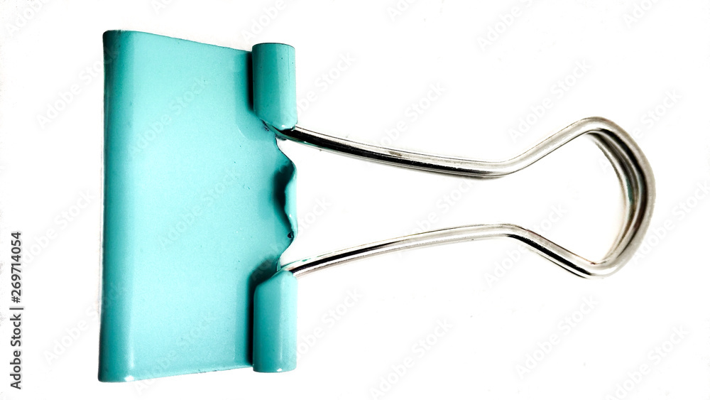 Obraz premium One turquoise paper clip closeup on a white background