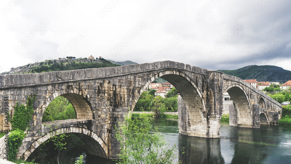 The historic monument of the Arslanagic bridge (old bridge) in Trebinje. Historical stone bridge and river in Bosnia and Herzegovina