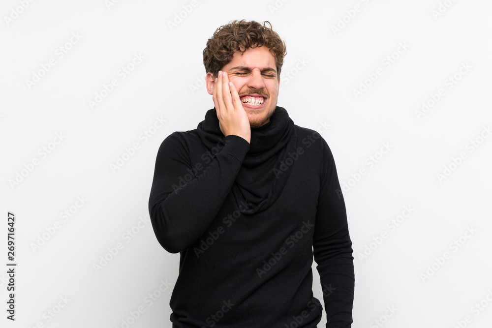 Blonde man over isolated white wall with toothache Blonde man over isolated white wall with toothache