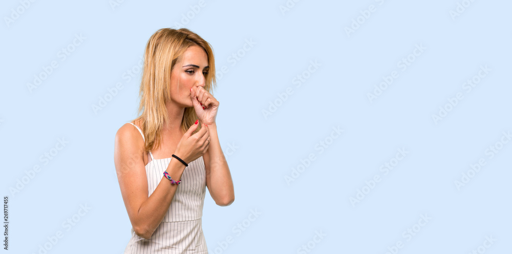Fototapeta premium Young blonde woman is suffering with cough and feeling bad over isolated blue background