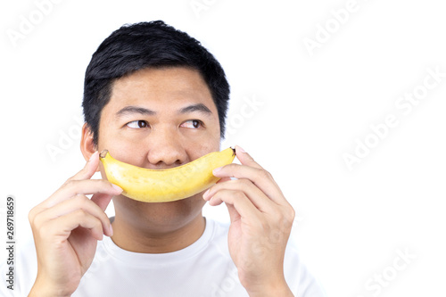 Man holding banana over face