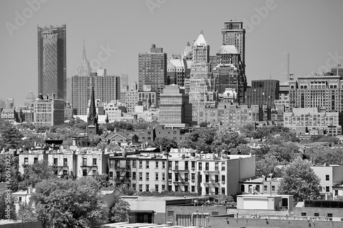 Black and white picture of Manhattan seen from Brooklyn neighborhood on a hazy summer day, USA.
