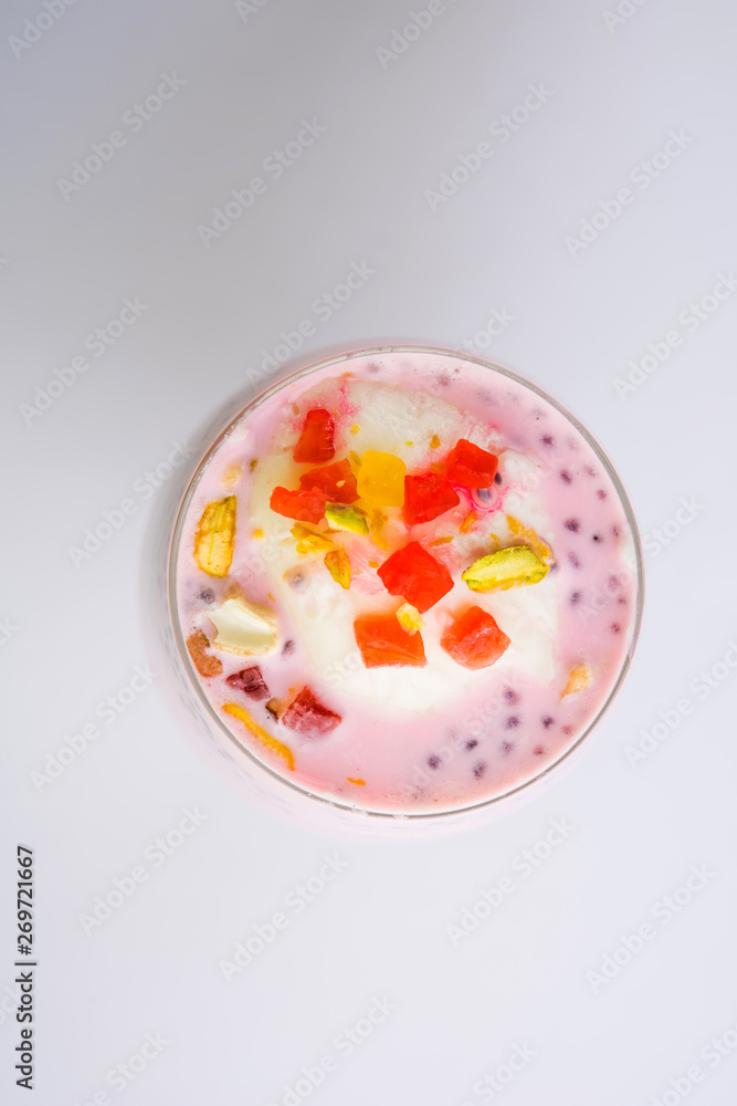 Falooda / Faluda is a popular Indian dessert - Strawberry and Mango flavoured which has Ice cream, noodles, sweet basil seeds and nuts, selective focus Falooda / Faluda is a popular Indian dessert - Strawberry and Mango flavoured which has Ice cream, noodles, sweet basil seeds and nuts, selective focus