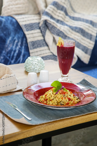 Tofu scramble and beetroot detox drink served on the restaurant table, healthy casual dining concept
