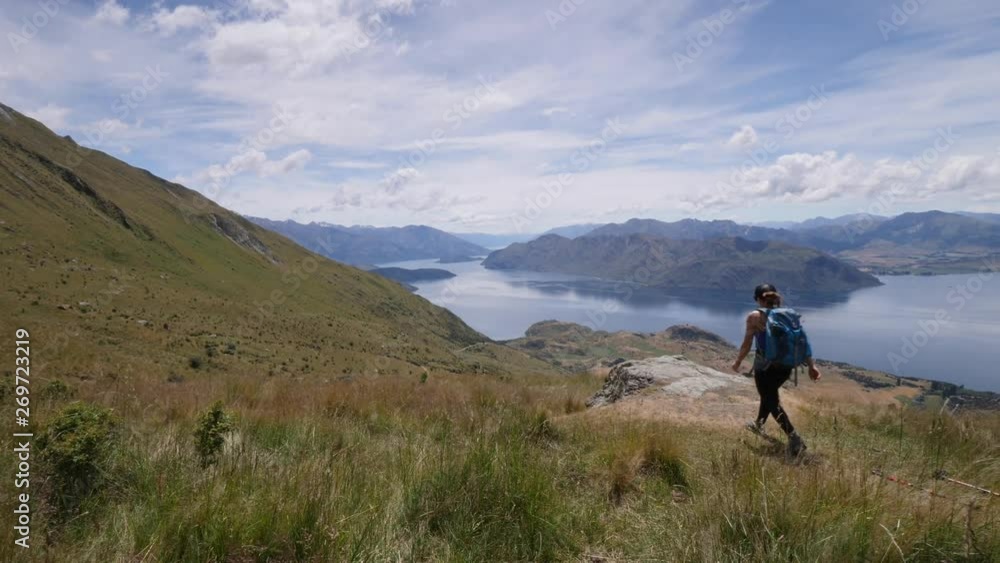Woman Hiking to peak in New Zealand Woman Hiking to peak in New Zealand