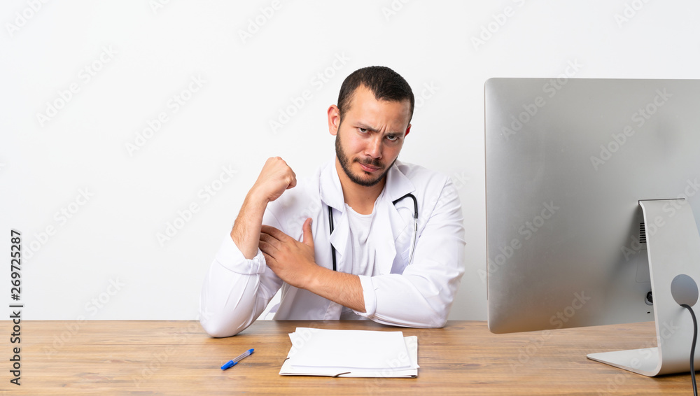 Doctor Colombian man doing strong gesture Doctor Colombian man doing strong gesture