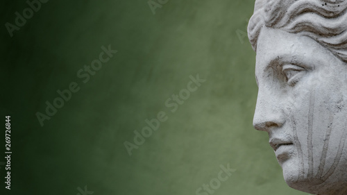Statue of ancient sensual naked Renaissance Era woman in Potsdam at smooth green gradient background, Germany