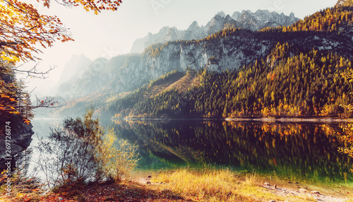 A magnificent panorama of the mountains at Vorderer Gosausee lake. Amazing Alpine Valley with fairy lake, with Azure Water. surrounded by Rocky Mountains. under sunlit. Wonderful Sunny Landscape