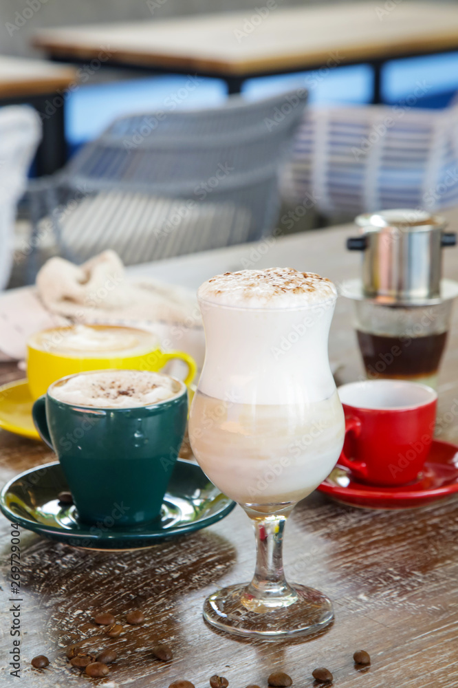 A cup of hot fresh coffee with rich foam on the wooden table A cup of hot fresh coffee with rich foam on the wooden table