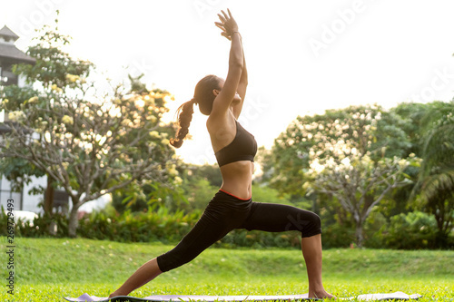 Photos girl doing yoga at sunset in Thailand in the park