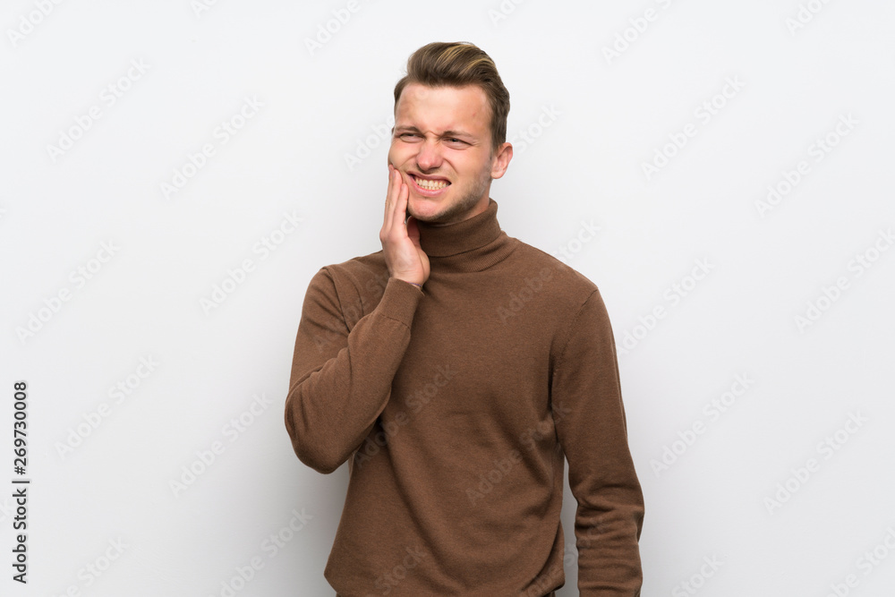 Blonde man over isolated white wall with toothache Blonde man over isolated white wall with toothache