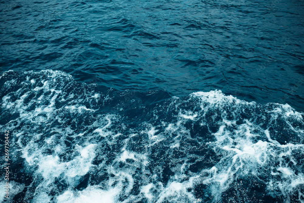Sea waves and foam from a cruise ship. Water background Sea waves and foam from a cruise ship. Water background