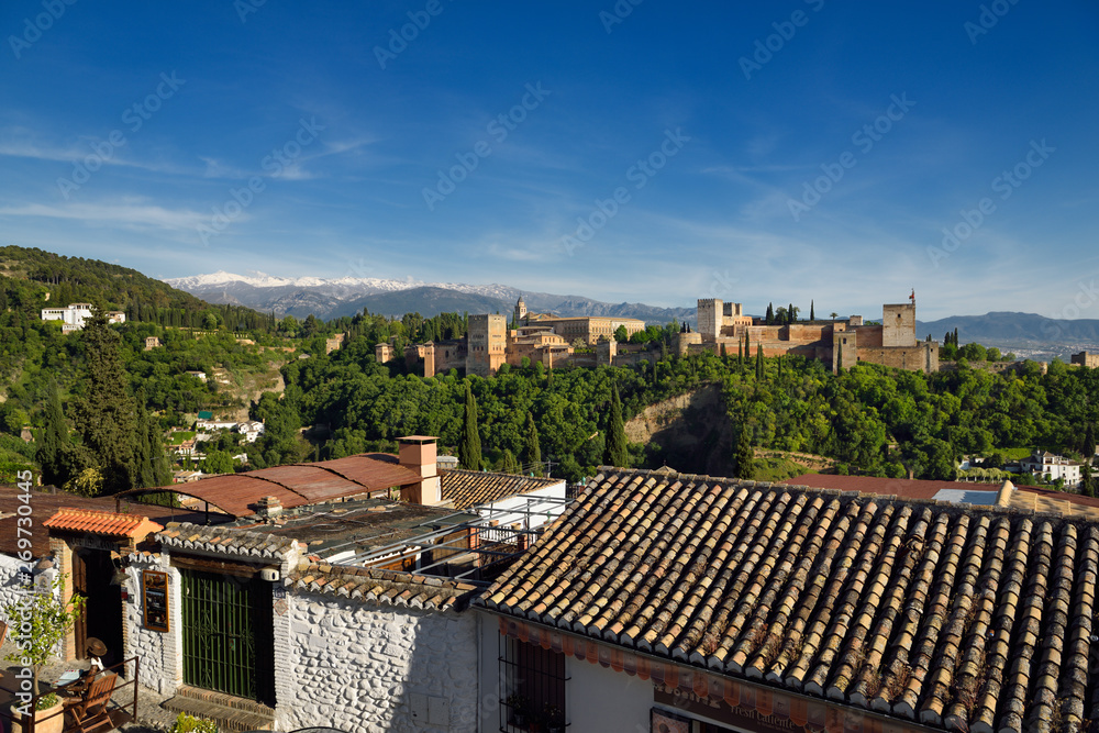 Albaicin restaurant at Saint Nicholas lookout with Generalife Alhambra fortress and Sierra Nevada Mountains Granada