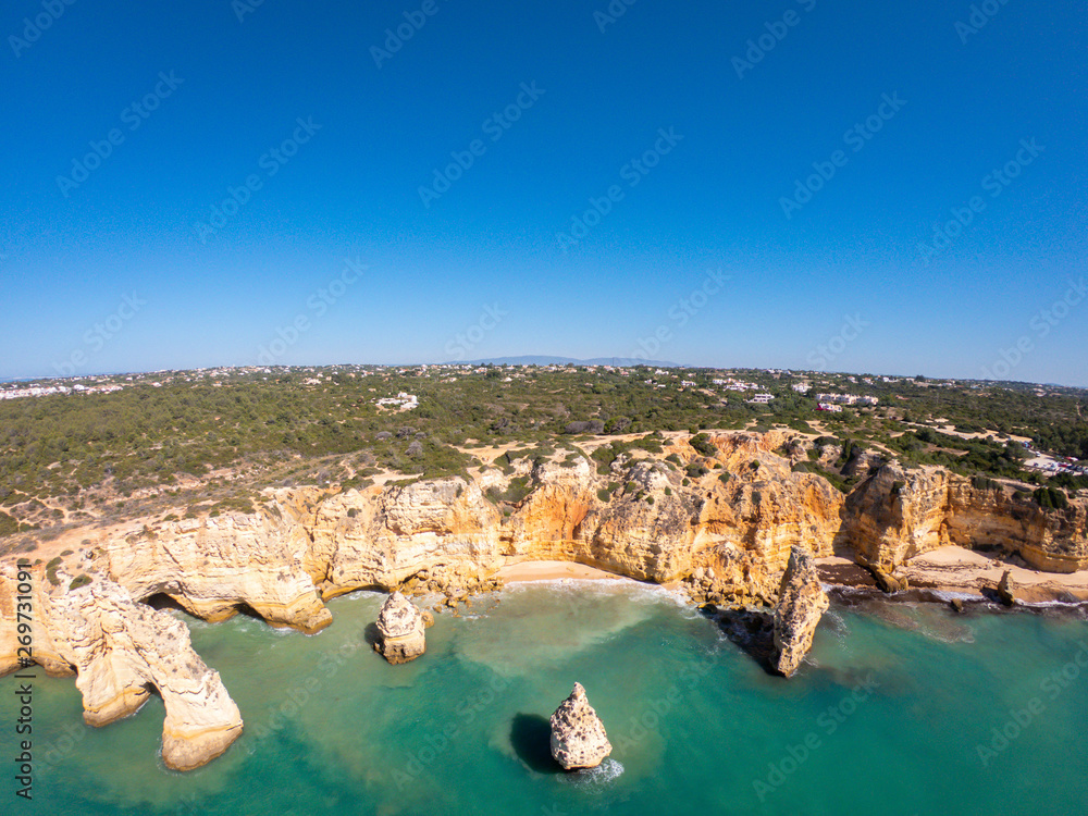Aerial view on Praia de Marinha in Algarve, Portugal. Rock formations and cliffs on coast of Atlantic Ocean 