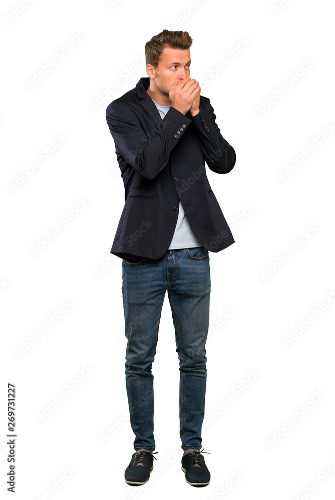 Blonde handsome man covering mouth and looking to the side Blonde handsome man covering mouth and looking to the side