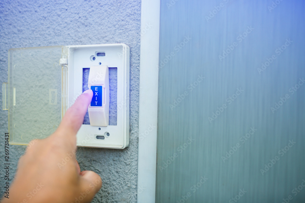 man push the white exit button on electronic panel. staff push exit button to open door man push the white exit button on electronic panel. staff push exit button to open door