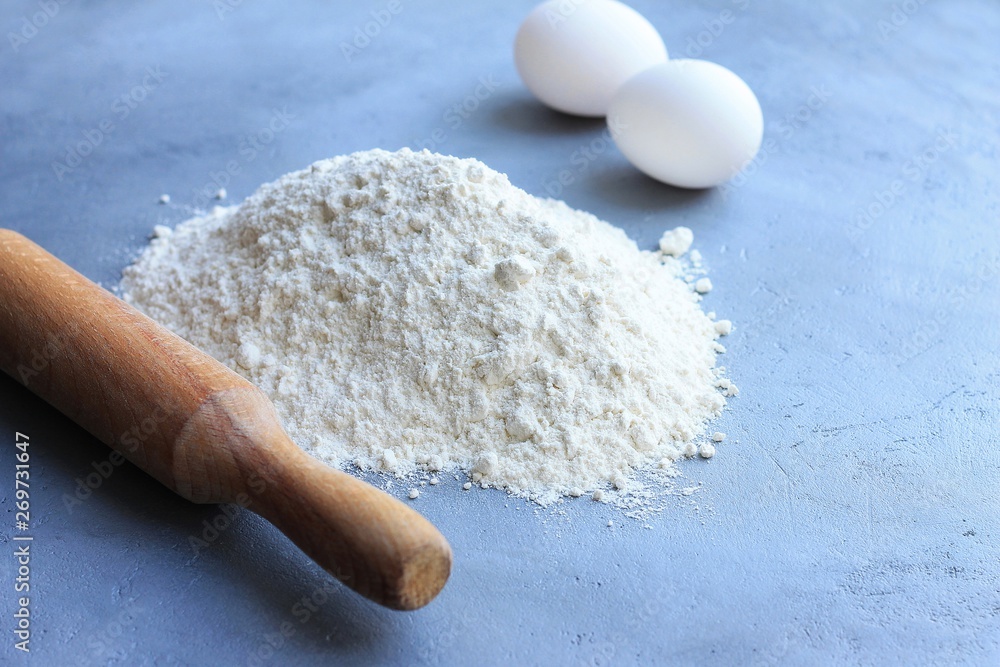 Preparation of dough, flour, eggs and rolling pin on gray background. Preparation of dough, flour, eggs and rolling pin on gray background.