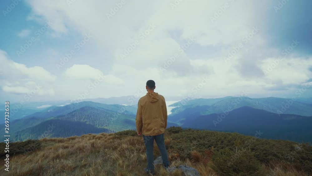 The happy man standing on the mountain with a beautiful landscape The happy man standing on the mountain with a beautiful landscape