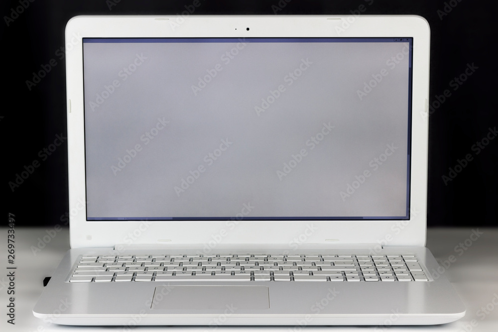copy spaсe, included, white laptop on a light table, dark background copy spaсe, included, white laptop on a light table, dark background
