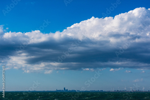 Clouds over water. Clouds against a blue sky. Blue sky with clouds on a sunny day.