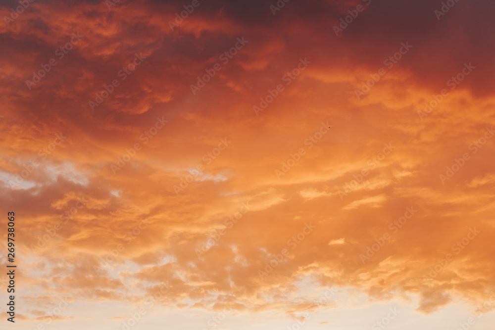 Obraz premium Orange red sunset with clouds in summer
