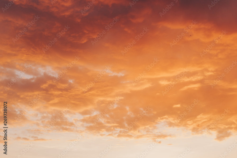 Obraz premium Orange red sunset with clouds in summer
