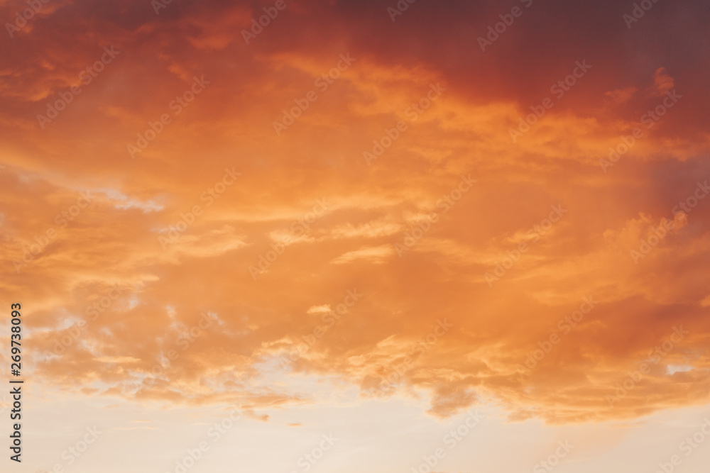 Obraz premium Orange red sunset with clouds in summer