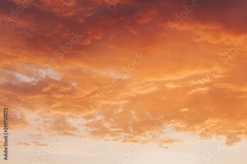 Orange red sunset with clouds in summer