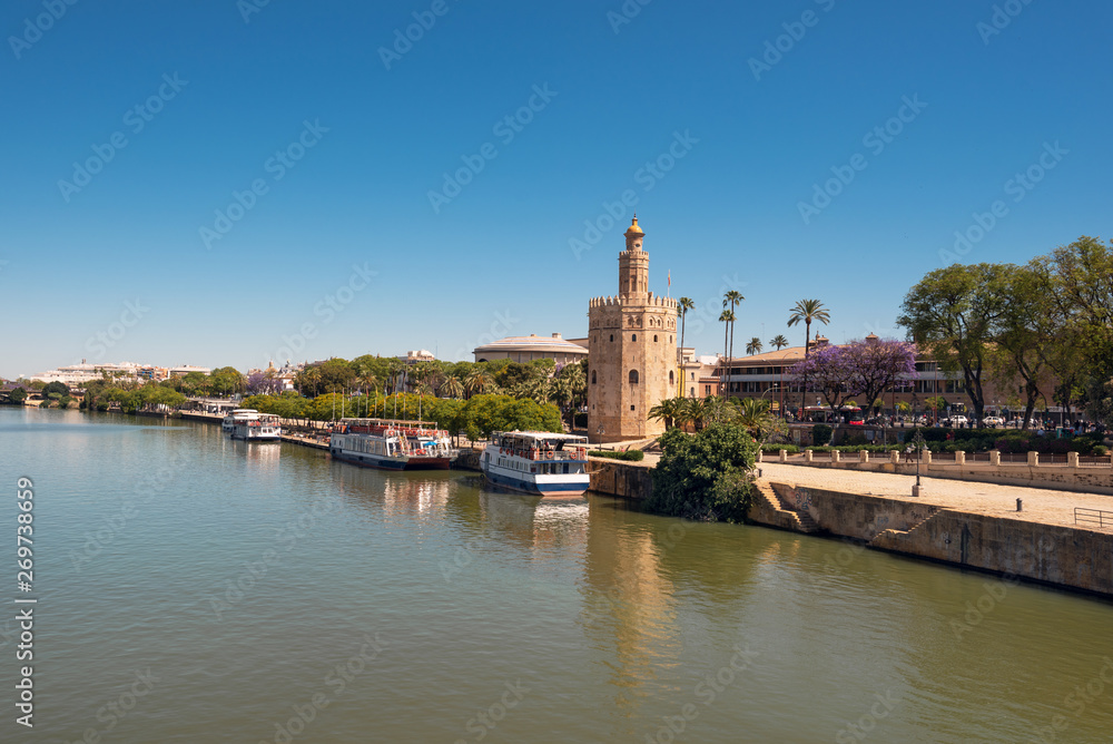 Golden tower Torre del Oro along the Guadalquivir river, Seville Andalusia , Spain .
