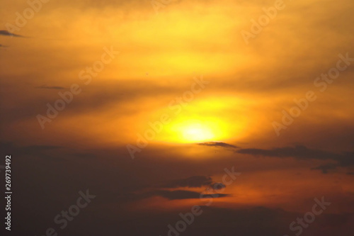 Dark clouds on an orange yellow sky. Sunset background