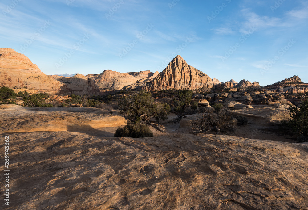Naklejka premium Pectols Pyramid is a prominent rock formation that is located with in Capital Reef National Park, Utah. Late afternoon light and shadows add to the dramatic landscape of the Utah desert.