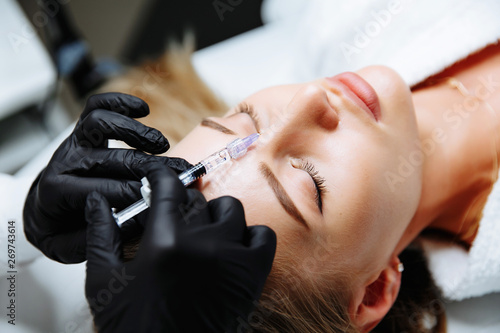 Portrait of female patient having modern noninvasive procedure of rhinoplasty,